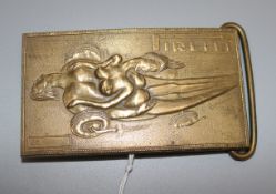 A Pirelli brass buckle with Salvador Dali design