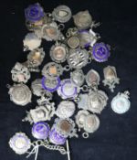 A collection of silver fobs/medallions.