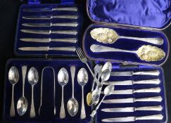 A cased matched pair of Georgian silver 'berry' spoons, a set of six teaspoons & tongs, two cased