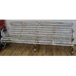 A 19th century white painted four seated slatted iron garden bench, W.212cm