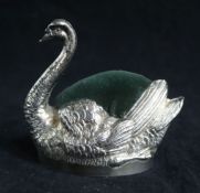 A large Edwardian novelty silver pin cushion modelled as a swan by Grey & Co, with inset leatherette