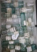 A quantity of vintage labelled glass chemist's bottles, a zinc ointment jar and a large collection