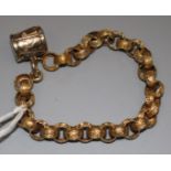 A late Victorian gold fancy link bracelet with drum charm.