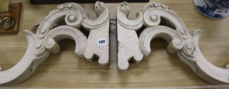 A pair of carved wood brackets