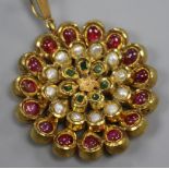 An Indian yellow metal and gem set flower head pendant, diameter 47mm.