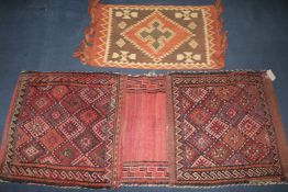 A Kashmiri wool rug with tree of life design, a Belouchi red ground saddle bag and an Indonesian