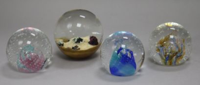 Three Caithness paperweights and one other