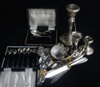 Two silver candlesticks and a small vase (weighted), an Asian embossed white metal small bowl and