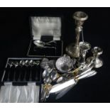 Two silver candlesticks and a small vase (weighted), an Asian embossed white metal small bowl and