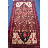 A Persian Kazak red ground rug, 200 x 100cm