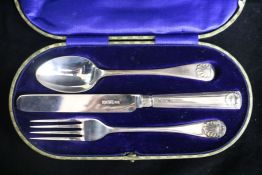 A George V silver christening trio by George Howson.