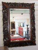 An oak framed mirror, H.82cm
