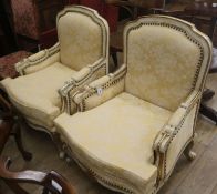 A pair of cream upholstered armchairs