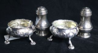 A pair of 1930's silver bun peppers and a pair of George III later embossed silver bun salts, 12