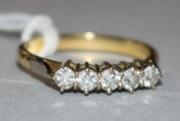 A yellow metal and five stone diamond ring, size M.