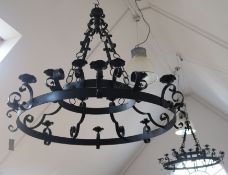 A pair of wrought iron chandeliers