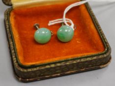 A pair of white metal mounted cabochon jadeite earrings with Gem & Peal Laboratory certificate dated