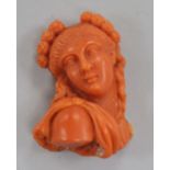 A carved coral bust of a lady (ex brooch mounted), 33mm.