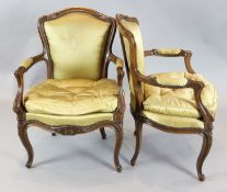 A pair of 19th century French walnut salon chairs, with gold silk upholstered arms, backs and seats,