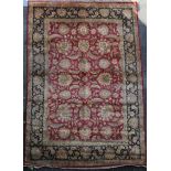 A large Agra red ground carpet, with gold floral decoration and three row floral borders and guards,