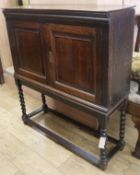 An oak cupboard on barley twist legs W.96cm