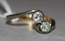 An 18ct gold and two stone diamond crossover ring, with a total diamond weight of approximately 0.