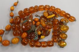 Assorted amber and simulated amber items including necklaces and bracelet.