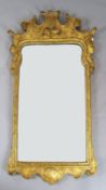 A mid 18th century style gilt gesso wall mirror, with Prince of Wales feather crest and bevelled