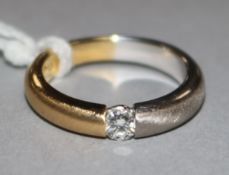 An 18ct two colour gold and solitaire diamond ring, size K.