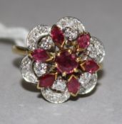 A yellow metal ruby and diamond cluster dress ring, size H.