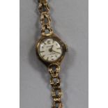 A lady's 9ct manual wind wrist watch on a 9ct gold bracelet.