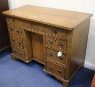 A George I style crossbanded walnut kneehole desk, W.98cm
