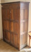 A panelled oak cupboard, H.184cm