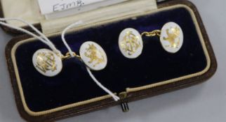 A pair of yellow metal and white enamel crested and monogrammed oval cufflinks, in box.