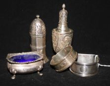 A group of George V silver including two pepper pots, two serviette rings and a salt.