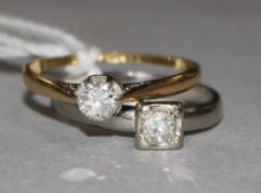 Two 18ct gold and solitaire diamond rings, one in white gold.