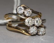 Two 1930's 18ct gold and two stone diamond rings and one yellow metal and two stone diamond ring.