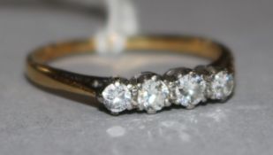 An 18ct gold and four stone diamond ring, size Q.