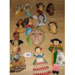 Ten Art Deco style plaster wall masks, various, a pair of figural plaques of a Spanish couple in