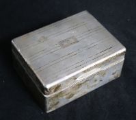 A silver engine-turned cigarette box, with initials to cover.