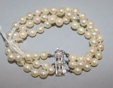 A triple strand cultured pearl bracelet with 14ct gold and cultured pearl set rectangular clasp,