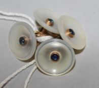 A pair of gold, mother of pearl and cabochon gem set circular cufflinks.