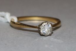 An 18ct gold and solitaire diamond ring, size O.