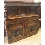 A 17th century style carved oak court cupboard, W.150cm