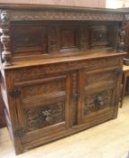 A 17th century style carved oak court cupboard, W.150cm