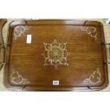A Wooden tray with handles and brass surround