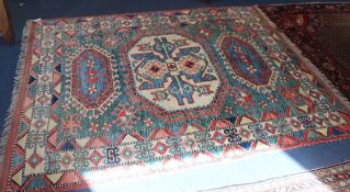 A Caucasian style blue ground rug, 210cm x 175cm