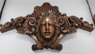 A carved panel of a face
