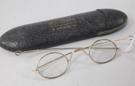 A pair of yellow metal wire-rimmed spectacles, in original optician's case