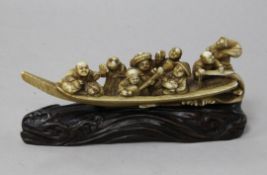 A Japanese ivory okimono of figures enjoying festivities on a boat, Meiji period, playing music